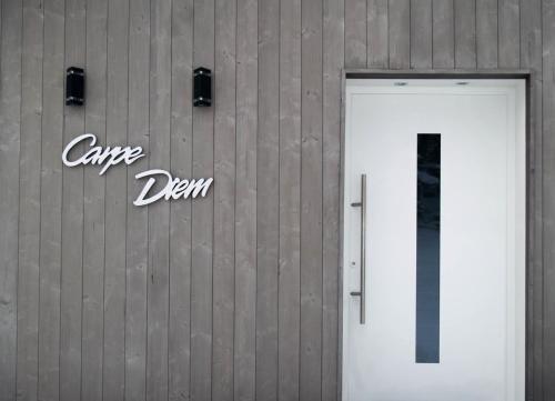 a door to a building with a sign on it at Apartment Carpe Diem in Kramsach