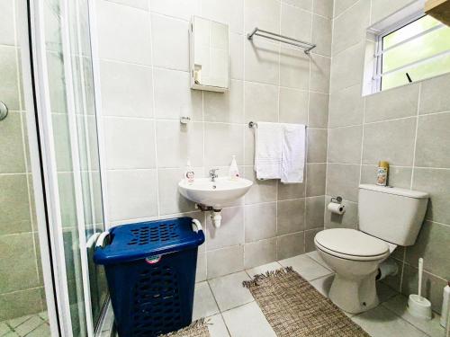 a bathroom with a toilet and a sink at House of Grace Apt in East London