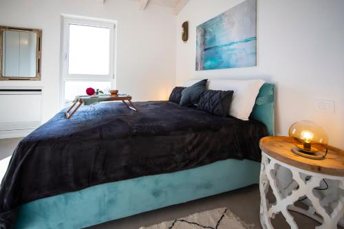 a bedroom with a large bed and a table at Sunrise in Cipressa
