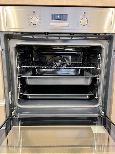 an oven with its door open in a kitchen at Arenas in Nivy