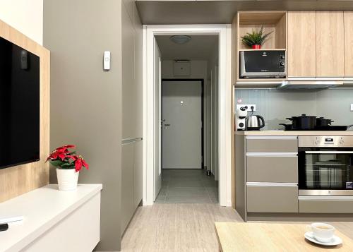 a kitchen with a door leading into a kitchen with a stove at Arenas in Nivy