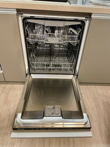 a dishwasher with its door open with a rack in it at Arenas in Nivy