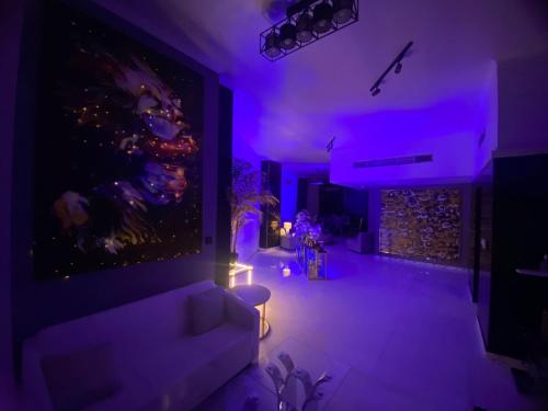 a living room with purple lights and a couch at Downtown Al Bahar Apartments in Dubai