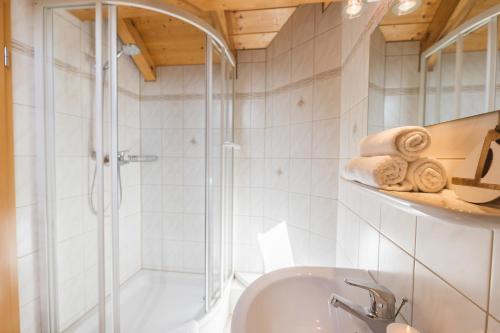 a bathroom with a shower and a sink at Ferienwohnung Seeglück mit großzügigem Südbalkon und herrlichem Seeblick in Schluchsee