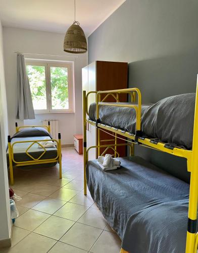 a room with two bunk beds and a window at Ostello Fiume Tirino in Bussi sul Tirino