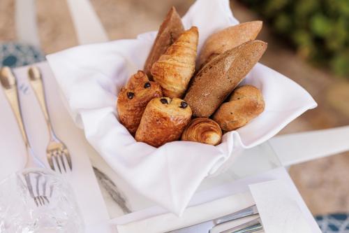 a bowl of bread and pastries on a table at Acanthus blue in Corfu Town
