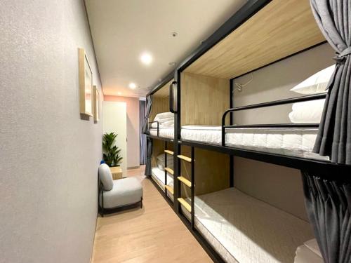 a small room with two bunk beds in it at Brosis Hotel in Busan