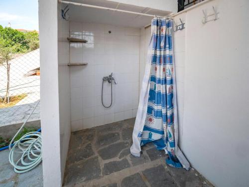 a shower in a bathroom with a shower curtain at Savas House in Paralía Avdhíron