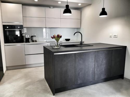 a kitchen with white cabinets and a black counter top at Holiday home in Selca with terrace, air conditioning, WiFi, washing machine 5094-1 in Selca