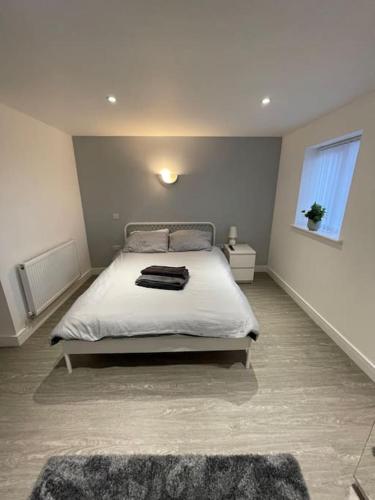 a bedroom with a bed and a window at 3 Studio close to amenities & transport links in Bristol