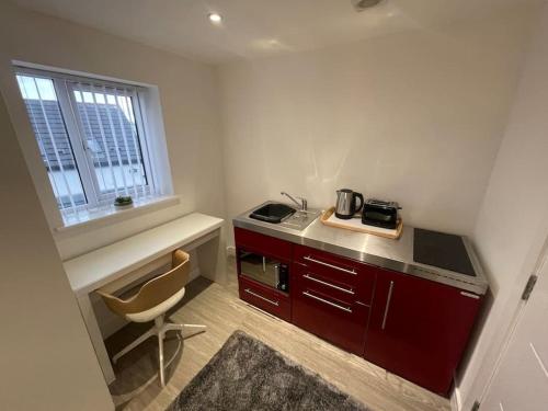 a kitchen with a counter and a chair in a room at 3 Studio close to amenities & transport links in Bristol