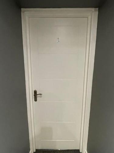 a white door with a handle in a room at 3 Studio close to amenities & transport links in Bristol