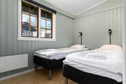 two beds in a room with a window at Topcamp Bogstad - Oslo in Oslo