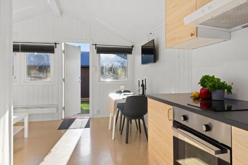 a kitchen and dining room with a table and chairs at Topcamp Bogstad - Oslo in Oslo