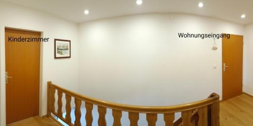 a room with a staircase with a white wall at Biohof Untergrabenbauer in Lidaun