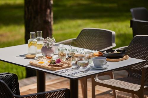 a table with a tray of food on it at ESE HOTEL in Birštonas