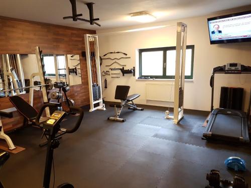 a room with a gym with chairs and a television at Landhotel BurgenBlick Garni & Tagungshotel in Erfurt
