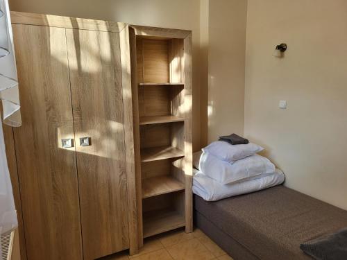 a bedroom with a closet and a bed with pillows at Hotelik OSiR Lubawa in Lubawa