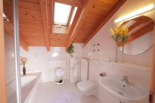 a bathroom with a tub and a toilet and a sink at Landhaus Fürberger in Anger
