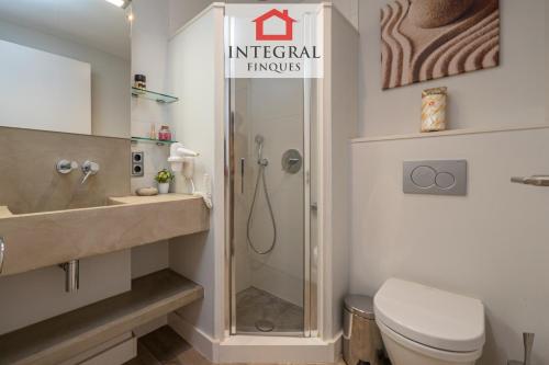 a bathroom with a shower and a toilet and a sink at Palamós Exclusive Apartments in Palamós
