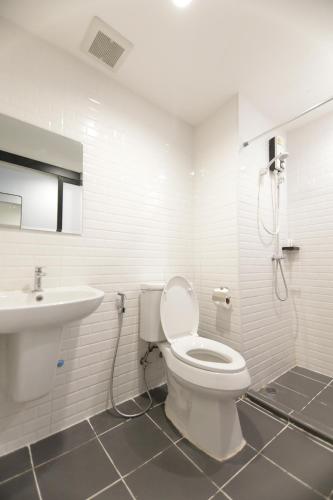 a bathroom with a toilet and a sink at WiRE BANGKOK PRAKHANONG in Amphoe Phra Khanong