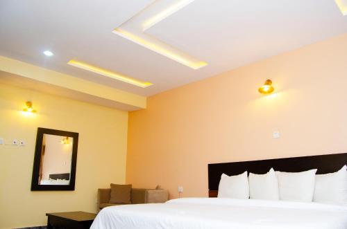 a hotel room with a bed and a mirror at Residency Hotel Area11 Garki Abuja in Abuja