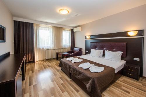 um quarto de hotel com uma cama com toalhas em Complex Panorama em Elena