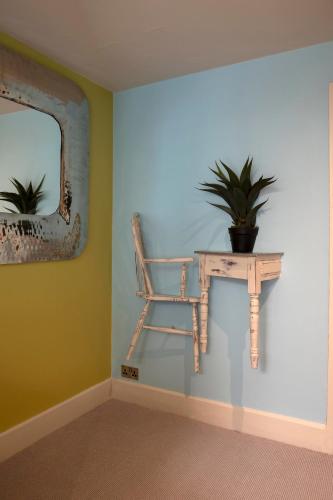 a room with a table and a chair and a mirror at Talland Bay Hotel, Looe in Talland