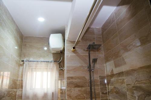 a bathroom with a shower with a shower curtain at Residency Hotel Area11 Garki Abuja in Abuja