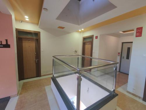 a empty room with a glass case in a building at Hotel Midtown Inn in Trimbak