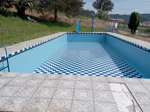 a blue swimming pool with blue tiles on the ground at Hotel Donas e Cabaleiros in Pousada