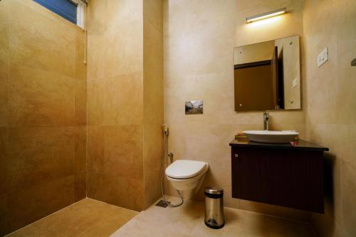 a bathroom with a toilet and a sink and a shower at Lantern Apart Hotel in Perintalmanna