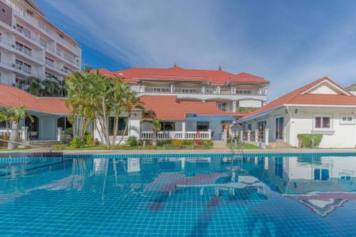 a swimming pool in front of a building at Resort 2-3BR Huge Pool, BBQ, 300m-Beach, 8 mins to Walking Street in Pattaya South