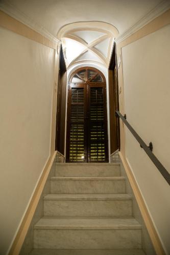 a staircase leading to a door in a building at La Perla della Cattedrale luxury home in Agrigento