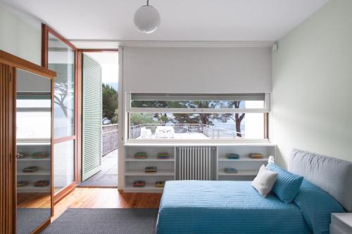 una camera con un letto e una grande finestra di Villa Glamour - Homelike Villas a Ossuccio
