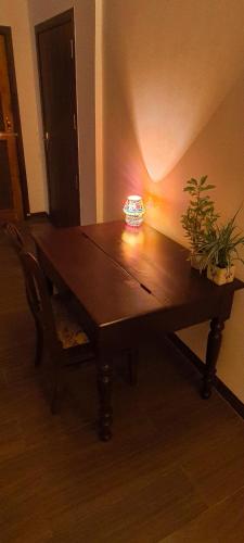 a wooden table with two plants on top of it at Gruham Homestay in Jorhāt
