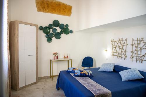 a bedroom with a blue bed and a balloon on the wall at La Perla della Cattedrale luxury home in Agrigento