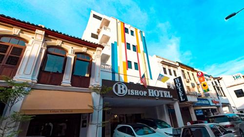 a building with a sign for a hotel on a street at Bishop Hotel in George Town