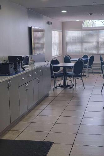 a room with a table and chairs in a room at Microtel Inn & Suites by Wyndham Gardendale - Birmingham North in Gardendale