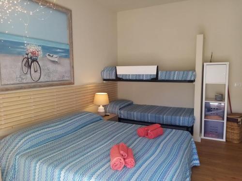 a bedroom with a bed with two red shoes on it at casa vacanze La Formica in Capo dʼOrlando