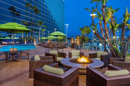 a patio with tables and chairs and a fire pit at Hyatt Regency Long Beach in Long Beach