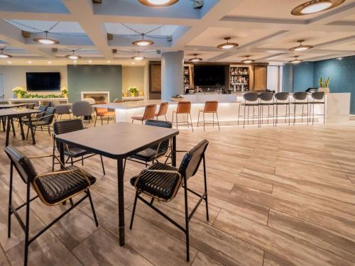a conference room with tables and chairs and a bar at Hyatt Regency Long Beach in Long Beach