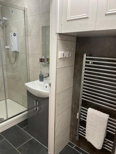 a bathroom with a sink and a shower at Courtyard Holiday Apartments in Belper