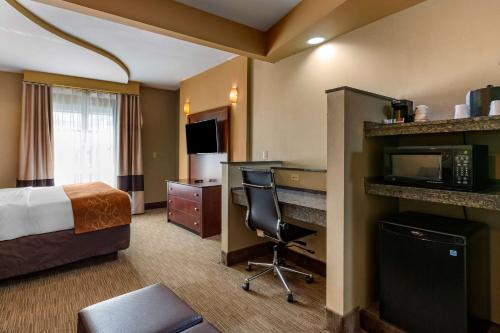 una camera d'albergo con letto e scrivania di Comfort Suites Perrysburg - Toledo South a Perrysburg