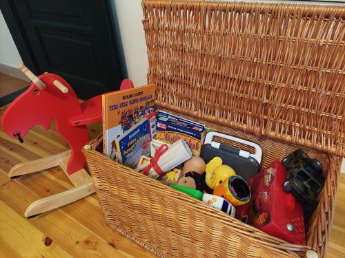 a basket with toys in it on the floor at 100 Éves Vendégház - Háromhuta in Háromhuta
