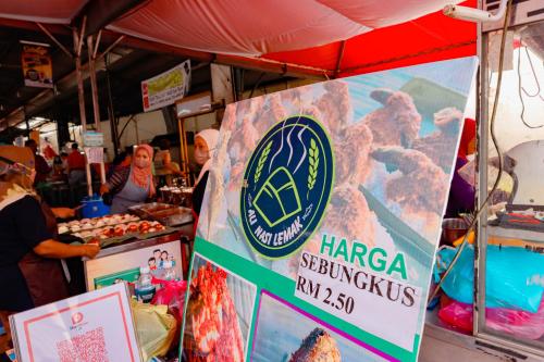 a market with a sign on the side of a tent at Bishop Hotel in George Town