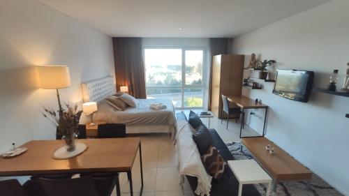a living room with a couch and a bed at Condominios W Nordelta Bahia,Tigre,Parking,Gym in Tigre