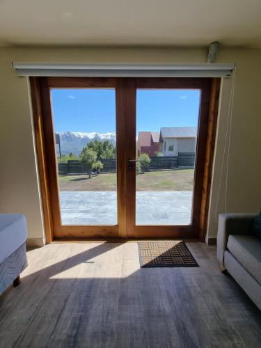a sliding glass door with a view of a house at Lomas Schuss ARG41 in San Carlos de Bariloche