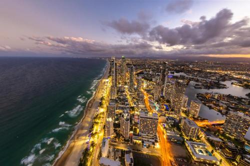 an aerial view of a city and the ocean at night at Meriton Suites Surfers Paradise in Gold Coast
