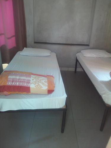 a pair of beds in a small room at Accoustix Backpackers Hostel in Johannesburg